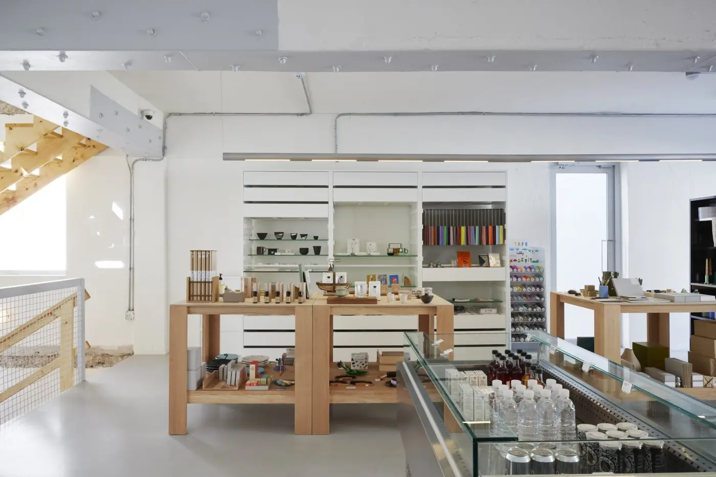Bright shop interior with objects displayed on wooden tables